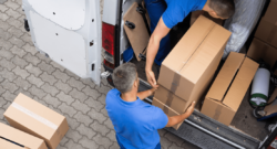 package delivery tuck with two people loading packages into back